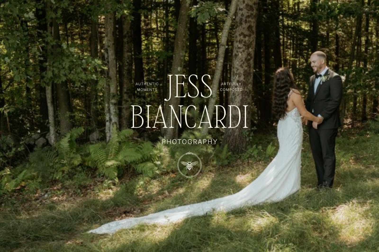Jess Biancardi Photography logo over a couple's first look in a sunlit New England forest