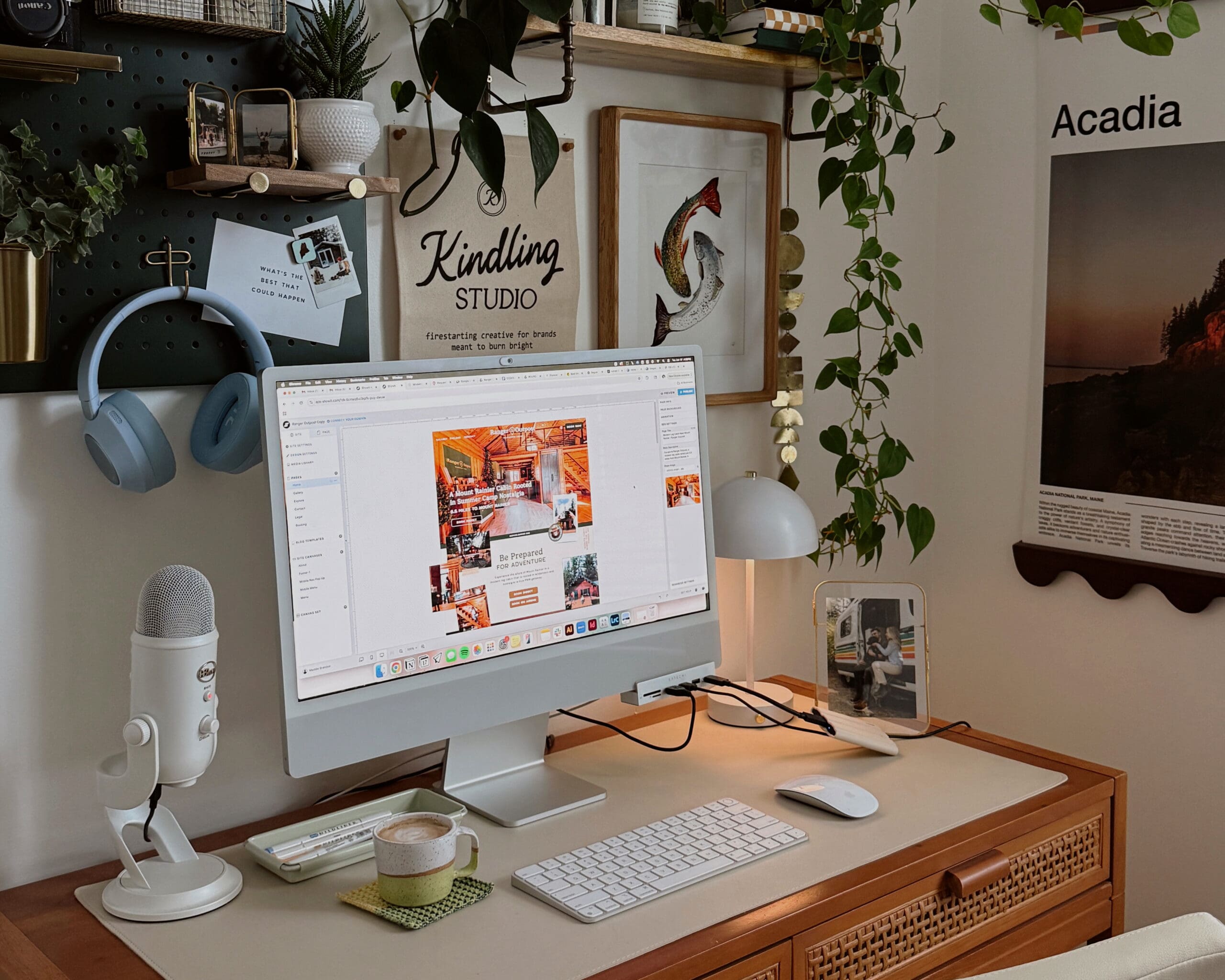 Laptop open to the Showit web design platform in a cozy, creative workspace setting